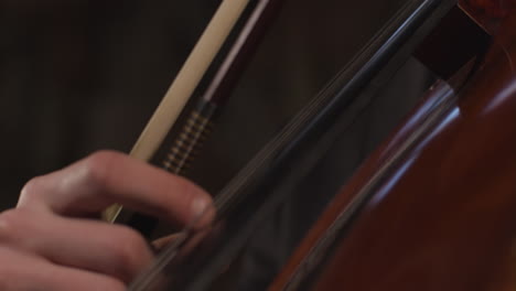 Pan-Down-Close-Up-Of-Male-Cellist-Plucking-Strings-On-Cello