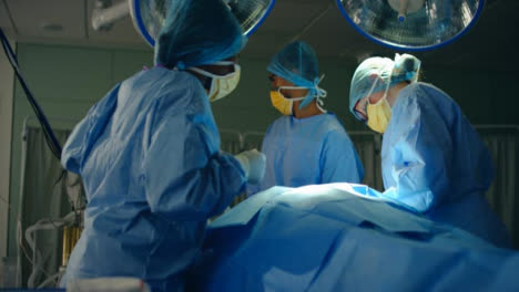 Pan-Medical-Staff-Picks-Up-Suction-Machine-During-Surgery