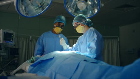 Pan-médico-Assistant-pasa-las-tijeras-al-cirujano