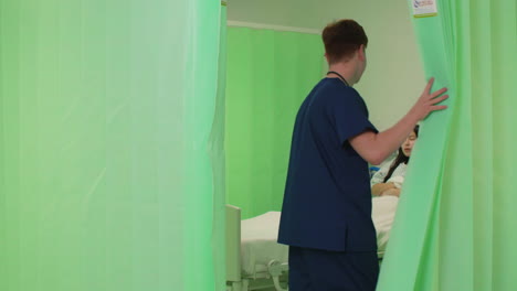 Male-Nurse-Opening-Hospital-Curtain