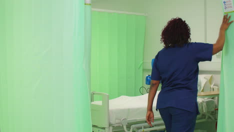 Female-Nurse-Opens-Hospital-Curtain