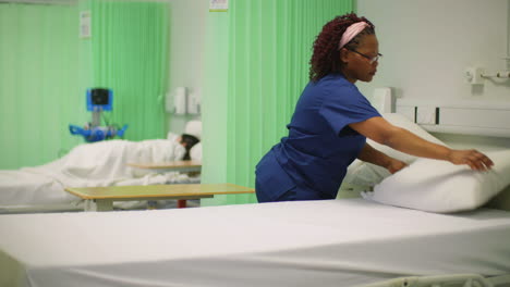 Female-Nurse-Making-Hospital-Ward-Bed