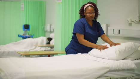 Nurse-Places-Pillow-on-Hospital-Bed
