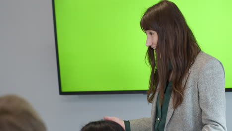 Businesswoman-Presenting-To-Colleagues-With-Green-Screen