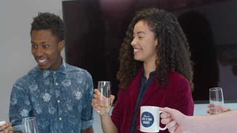 Colleagues-Celebrate-And-Toast-Drinks-In-Office