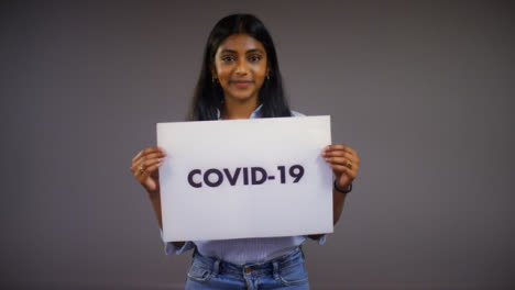 Young-Woman-Rips-Covid-19-Sign-Portrait