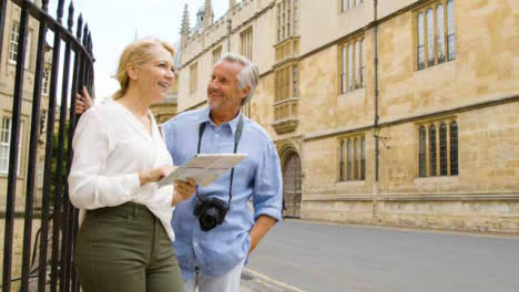 Medium-Shot-of-Middle-Aged-Tourist-Couple-Reading-a-Map-
