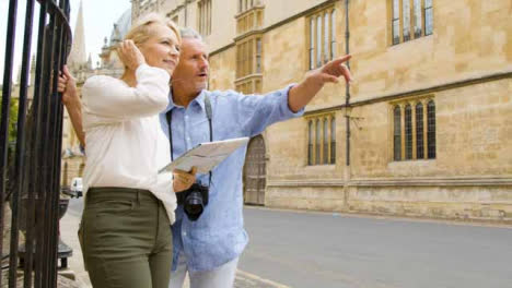 Medium-Panning-Shot-of-Middle-Aged-Couple-Reading-a-Map