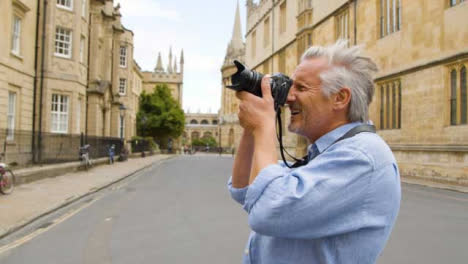 Tracking-Close-Up-of-Middle-Aged-Tourist-Taking-Photo-In-City