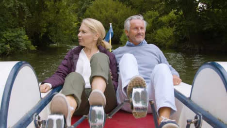 Wide-Shot-of-Middle-Aged-Tourist-Couple-In-Pedal-Boat