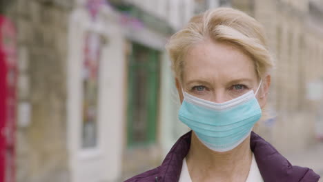 Close-Up-of-Middle-Aged-Woman-Wearing-Face-Mask-In-City