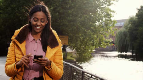 Tracking-Shot-of-Woman-Texting-and-Enjoying-Walk-by-Canal
