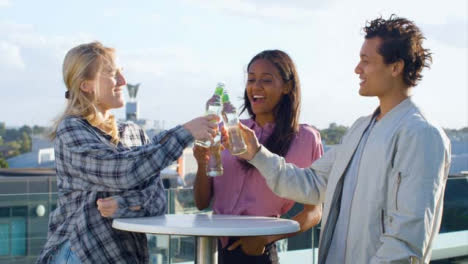Medium-Shot-of-3-Friends-Enjoying-a-Rooftop-Drink