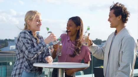 Medium-Shot-of-3-Friends-Enjoying-a-Drink-On-Roof-Terrace