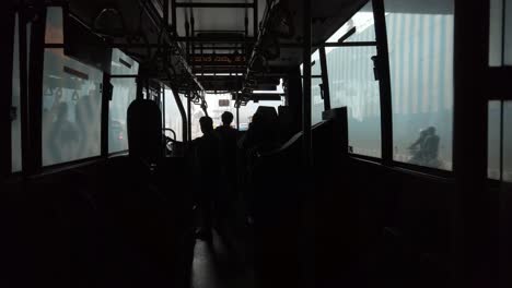 Wide-angle-shot-of-the-inside-of-a-public-bus-during-day-time-less-crowded-due-to-corona-virus-fear