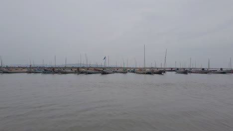 Wide-angle-view-of-fishing-boats-anchored-near-a-Jetty-in-Irukkam-Island-situated-in-Pulicat-lake-Andhra-Pradesh-India