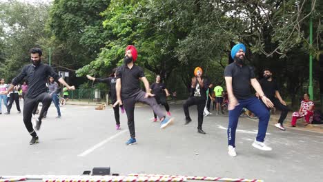 Bengaluru-Karnataka--India--September-1-2019-Slow-motion-shot-of-a-Punjabi-flash-mob-perfroming-bhangra-dancing-to-a-song-in-Cubbon-park-on-a-bright-day