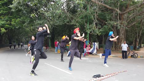 Slow-motion-shot-of-a-Punjabi-flash-mob-perfroming-bhangra-dancing-to-a-song-in-Cubbon-park-on-a-bright-day