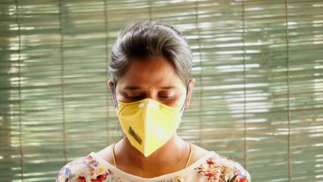 Closeup-of-an-Indian-women-showing-how-to-wear-a-safety-N95-mask-and-eye-protection-correctly-to-safeguard-from-Covid19-Coronavirus