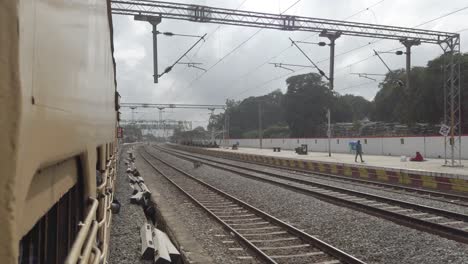 Vaniyambadi-Tamilnadu--India--December-14-2019-View-from-the-window-of-a-interstate-train-entering-a-railway-station-on-an-overcast-day