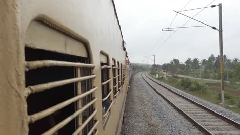 Aambur-Tamilnadu--India--December-14-2019-View-from-the-window-of-a-interstate-train-travelling-at-high-speed-on-a-straight-track-on-an-overcast-day