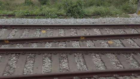 Closeup-of-the-railway-tracks-from-a-fast-moving-train-during-daytime