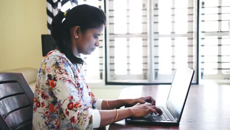 Closeup-of-Indian-business-woman-working-from-home-sitting-at-table-due-to-the-covid19-coronavirus-lockdown.
