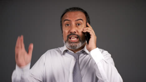 Smart-Frustrated-Middle-Aged-Man-Shouting-On-Phone-Portrait