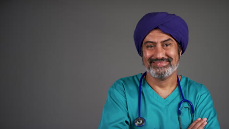 Middle-Aged-Doctor-In-Turban-Folding-Arms-and-Smiling-Portrait