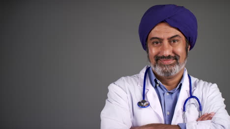 Middle-Aged-Doctor-In-Turban-Folding-Arms-and-Smiling