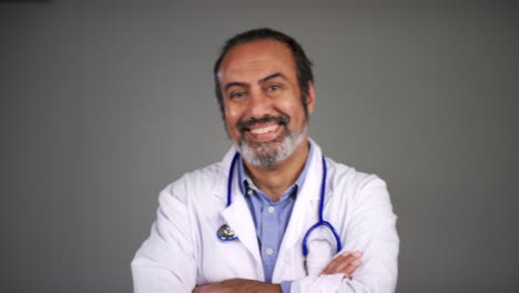 Pull-Focus-of-Middle-Aged-Doctor-Folding-Arms-and-Smiling