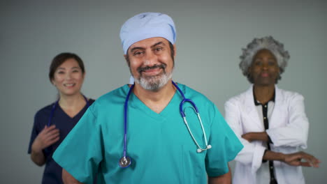 Pull-Focus-of-Three-Kind-Middle-Aged-Doctors-Smiling-Portrait