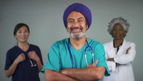 Pull-Focus-of-Three-Happy-Middle-Aged-Doctors-Smiling-Portrait