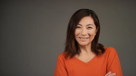 Middle-Aged-Woman-Folding-Arms-and-Smiling-Portrait