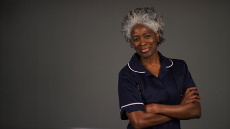 Middle-Aged-Nurse-Folding-Arms-and-Smiling-