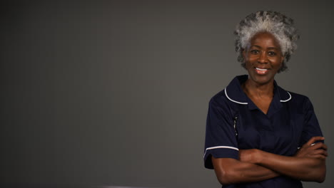 Middle-Aged-Nurse-Folds-Her-Arms-and-Smiles