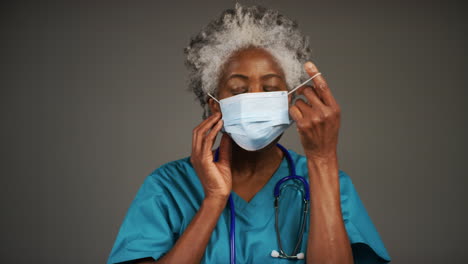 Middle-Aged-Doctor-Removing-Face-Mask-and-Smiling-Portrait