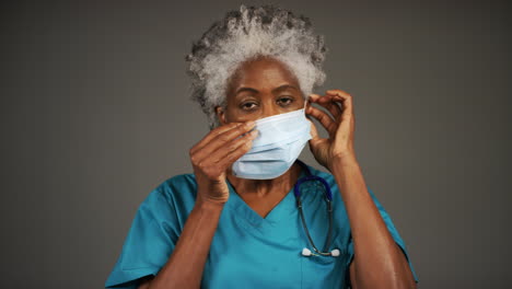 Middle-Aged-Doctor-Putting-On-Face-Mask-Portrait