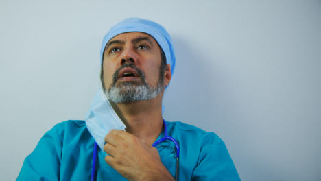 Tired-Middle-Aged-Surgeon-Wiping-His-Brow-and-Sighing-
