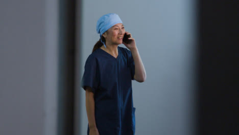 Middle-Aged-Surgeon-Talking-On-Her-Mobile-Phone