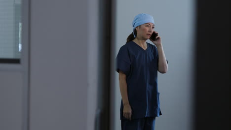 Concerned-Middle-Aged-Surgeon-Talking-On-Her-Mobile-Phone