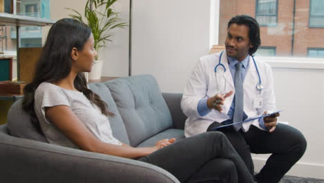 Young-Woman-Having-Relaxed-Chat-with-Doctor