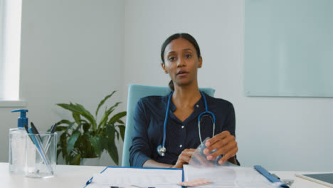 Young-Female-Doctor-Listening-During-Video-Meeting