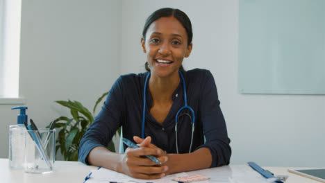 Happy-Young-Female-Doctor-Listening-During-Video-Meeting