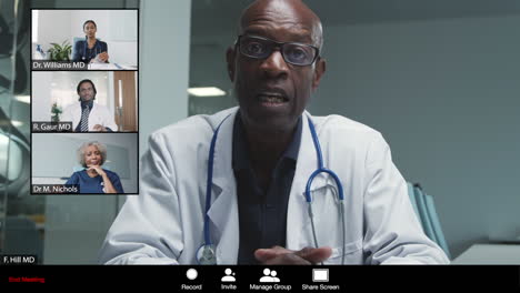 Middle-Aged-Male-Doctor-Leading-Video-Meeting-with-Colleagues