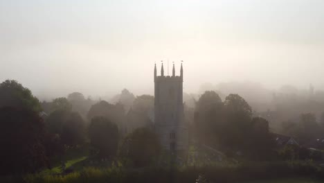 Drone-Shot-Orbiting-Islip-Church-In-Mist-03