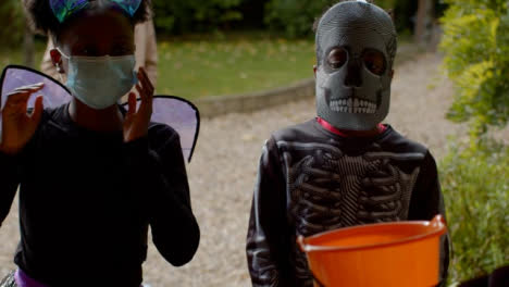 Children-in-Halloween-costumes-wearing-masks