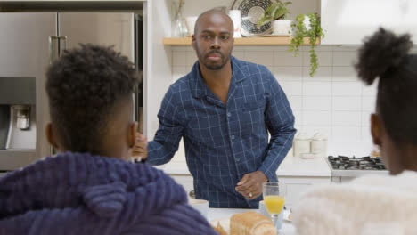 Father-Preparing-Breakfast-for-His-Two-Teenage-Children