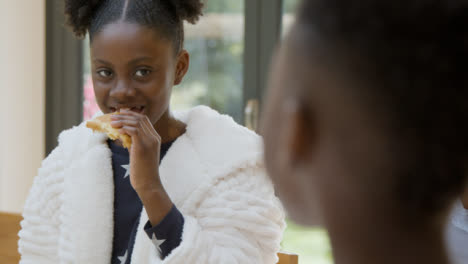 Young-Girl-Laughs-with-Her-Brother-at-Family-Breakfast