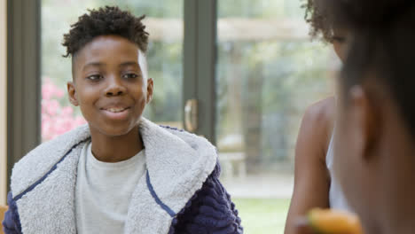 Young-Boy-and-His-Sister-Talking-Over-Family-Breakfast